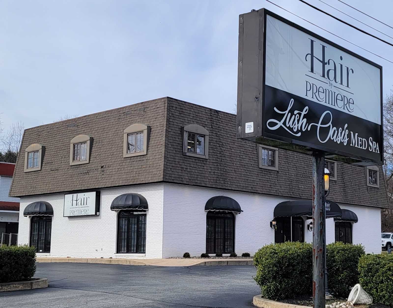 Exterior of Hair Premiere Lush Oasis Med Spa with signage and parking lot in view.